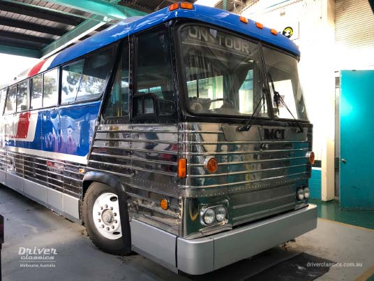 1976 MCI MC8 under restoration, Mt Waverley VIC, July 2019 MCI MC8 bus (1976 version), front and side, under restoration, in workshop, Pepsi red white and blue stripes, Mt Waverley VIC, Photo taken July 2019