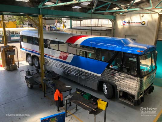 1976 MCI MC8 under restoration, Mt Waverley VIC, April 2019 MCI MC8 bus (1976 version), under restoration, in workshop, Pepsi chevron red white and blue stripes, Mt Waverley VIC, Photo taken April 2019