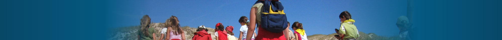 Children walking along beach at school camp