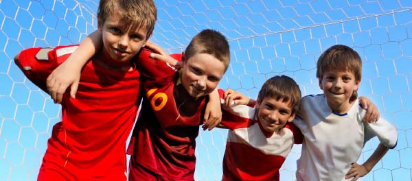 Soccer boys huddle up for photo at school sports